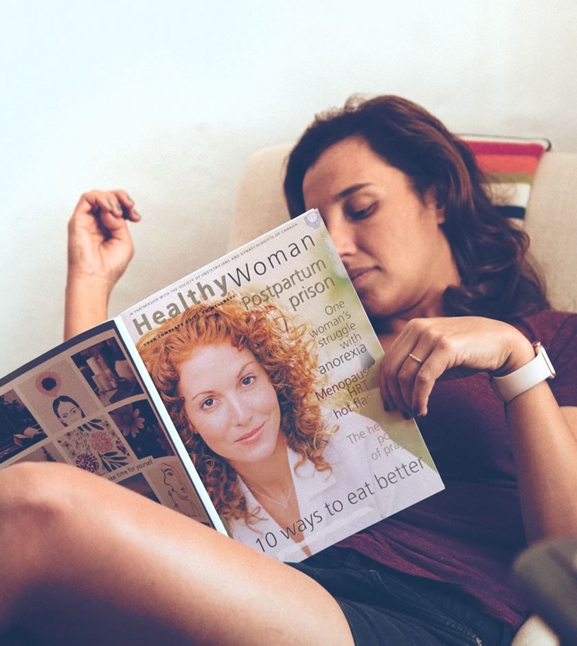 Young adult reading magazine