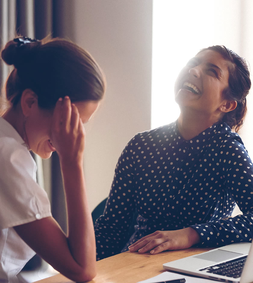 Business professional laughing with colleague