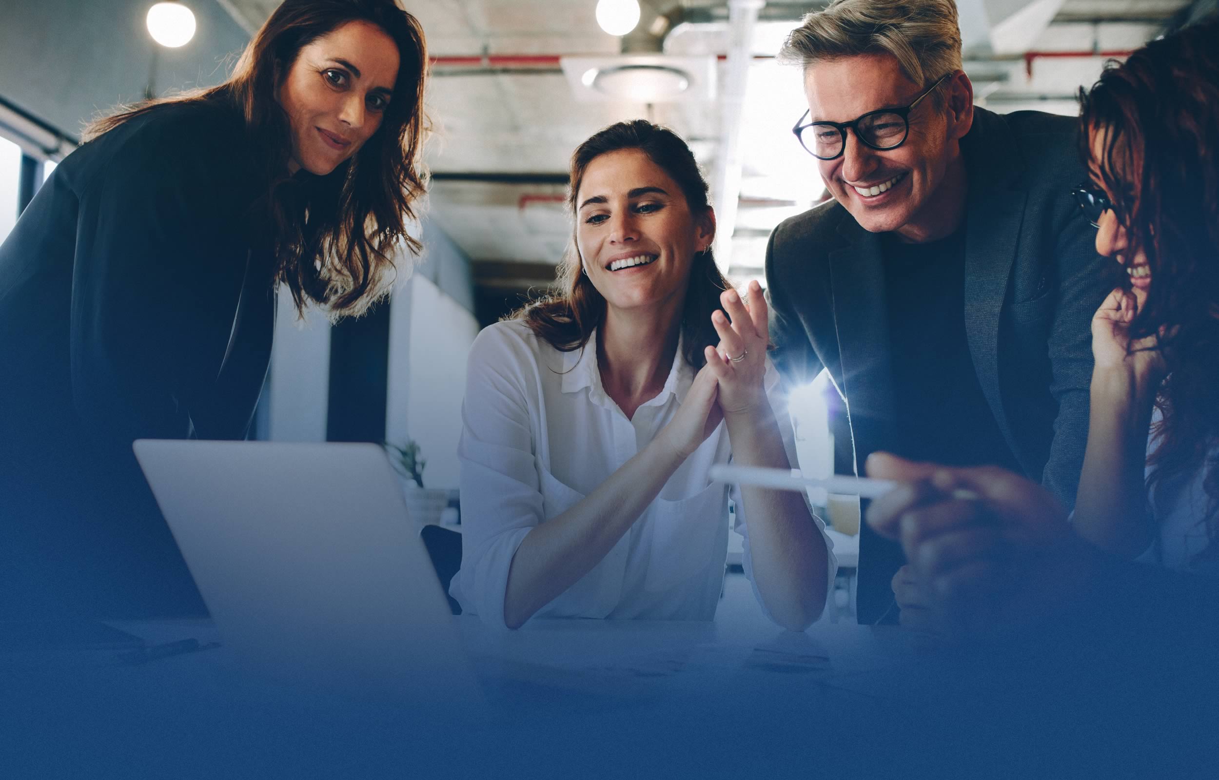 Business professionals reacting to content viewed from a laptop